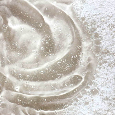 Swatch of Turmeric Glow Foaming Cleanser, clear liquid with foam on top.