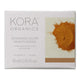 Kora Organics Turmeric Glow Moisturizer packaging with turmeric powder on a white background.