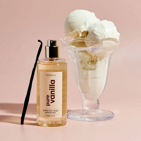 Perfume bottle labeled 'Lavanila Pure Vanilla' next to a glass of ice cream on a pink background.