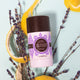 Lavanila The Healthy Deodorant Vanilla Lavender 57g lifestyle shot of the stick among lavender sprigs and orange peel, close up of the stick