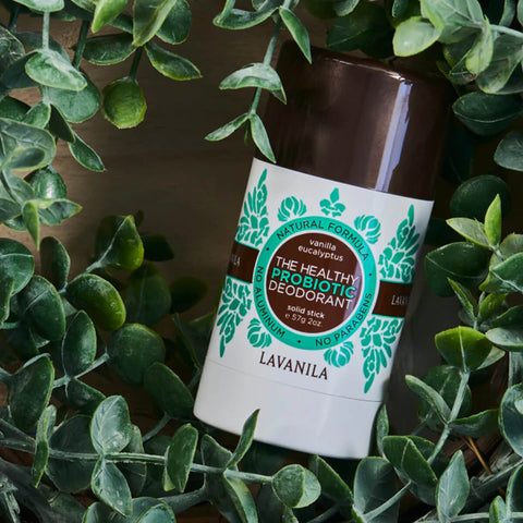 Lavanila The Healthy Probiotic Deodorant Vanilla Eucalyptus 57g lifestyle shot of the stick lying among green eucalyptus leaves