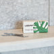 Leaf Shave Single-Edge Blades 50 blades lifestyle shot of the box and loose blades on a bathroom shelf, styled lifestyle photo