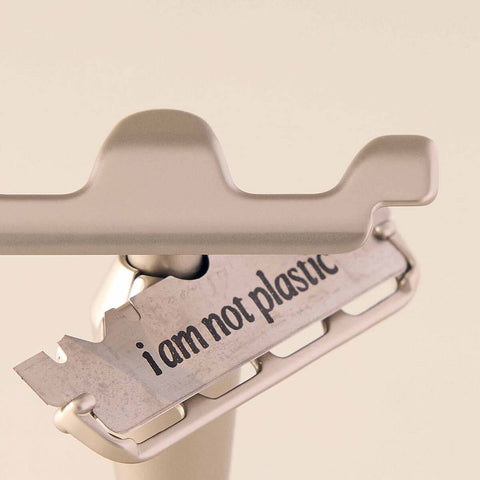 Leaf Shave Single-Edge Blades 50 blades lifestyle close up of a blade in a razor, stamped with the words I am not plastic, styled lifestyle photo