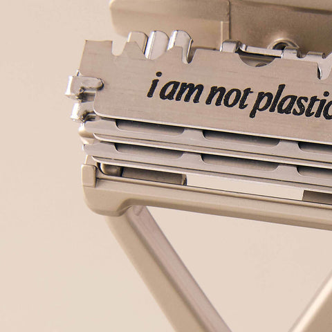 Leaf Shave Single-Edge Blades 50 blades lifestyle close up of a razor head and stacked blades stamped I am not plastic, styled lifestyle photo