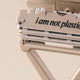 Leaf Shave Single-Edge Blades 50 blades lifestyle close up of a razor head and stacked blades stamped I am not plastic, styled lifestyle photo