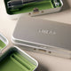 Leaf Shave Single Edge Travel Case lifestyle shot of two metal cases, one closed with the Leaf logo and one open, on a pale surface