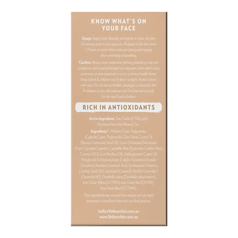 A beige product box with black text detailing the usage, caution, and ingredients of tinted sunscreen.