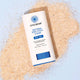 20g tube of Natural Zinc Stick SPF 50+ laying on sand.