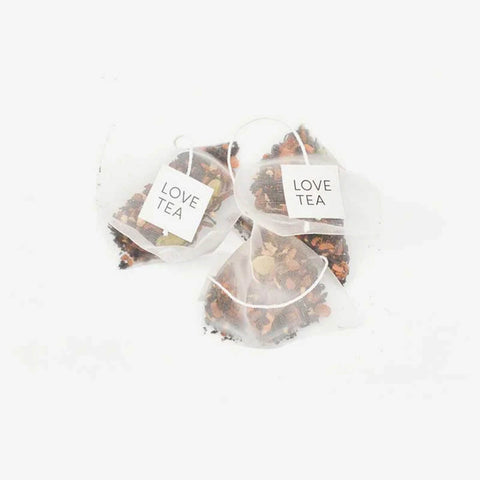 Love Tea Original Chai Pyramid Tea Bags, three pyramid tea bags with Love Tea tags on a plain white background, clear product photo