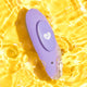 Waterproof purple silicone vibrator in water on a yellow background. 