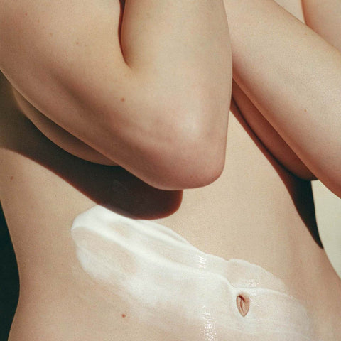 Close-up of a person's waist with the body cream applied. 