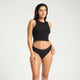 Model wearing Modibodi Classic Bikini Light-Moderate in black, front view of period underwear.