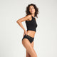 Model wearing Modibodi Sensual Hi Waist Bikini Light-Moderate in black, side view of period underwear.