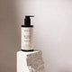 200ml pump bottle Mukti Red Velvet Body Oil placed on a stone, certified organic and suitable for all skin types.