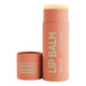 Noosa Basics Organic Lip Balm Guava 15g in a coral pink cardboard tube with its cap lying beside it on a plain white background
