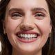Close-up of a woman's face wearing Flawless Concealer in Shell Beige shade.