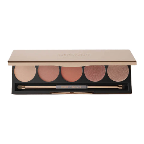 Makeup palette with six circular shades and two applicators on a white background.