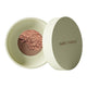 Green 10g container of Nude By Nature Natural Mineral Cover Blemish Control in shade light-medium. White background. 