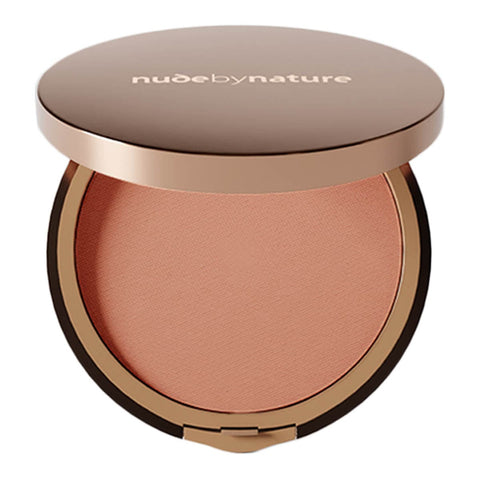 Compact blush with 'nude by nature' branding on a white background.