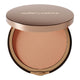 Compact powder in a round container with 'nude by nature' branding on a white background.