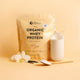 Nutra Organics Organic Whey Protein - Vanilla 750g package with vanilla flowers and a scoop on a yellow background.