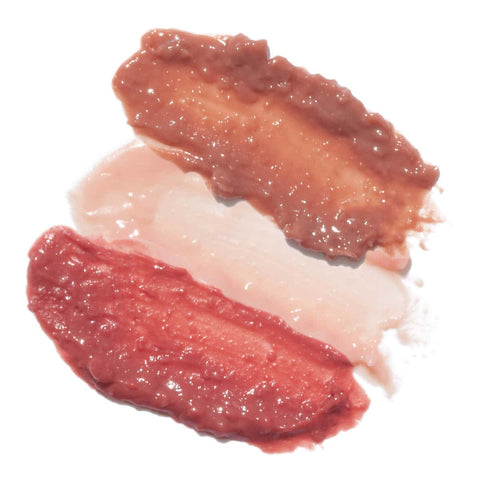 Oceanly Lip Gloss swatch, three glossy smears in brown, pale pink and red, close up on a plain white background, clear product photo