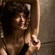 Woman applying Papermoon Clean Deodorant - Unscented 75g in front of a mirror.