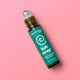 Roll-on bottle of 'Itch Away' by Plant Therapy on a pink background