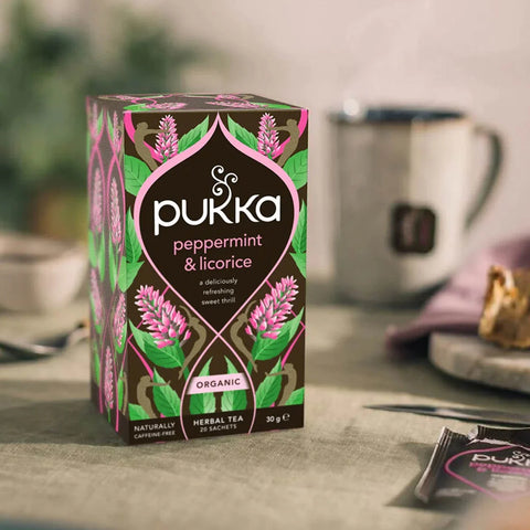 Pukka Peppermint & Licorice tea box on a table with a blurred background