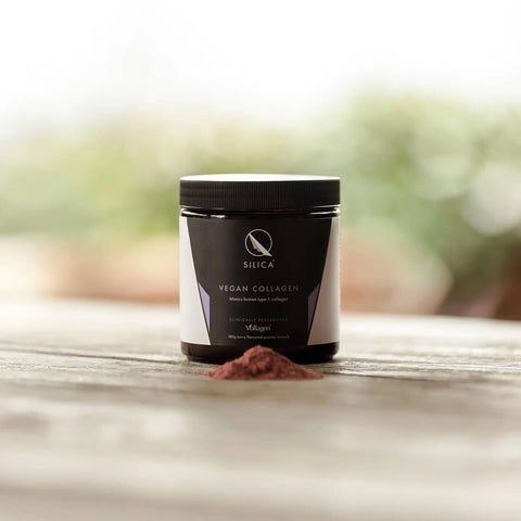 Jar of Qsilica Vegan Collagen powder with a blurred natural background.