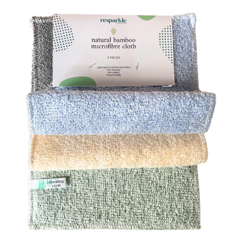 Resparkle Bamboo Micro-Fibre Cloths detail shot of three folded cloths in grey, tan and green beside the cream card label on a plain white background