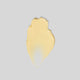 Yellow creamy swatch on a grey background.