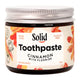 Jar of Solid Toothpaste Cinnamon with Fluoride on a white background
