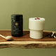 Superfeast Shen supplement bottle on a wooden surface with a white glass and spoon.