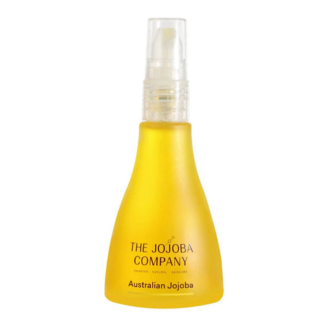 Yellow bottle with a clear spray nozzle labeled 'The Jojoba Company Australian Jojoba' on a white background