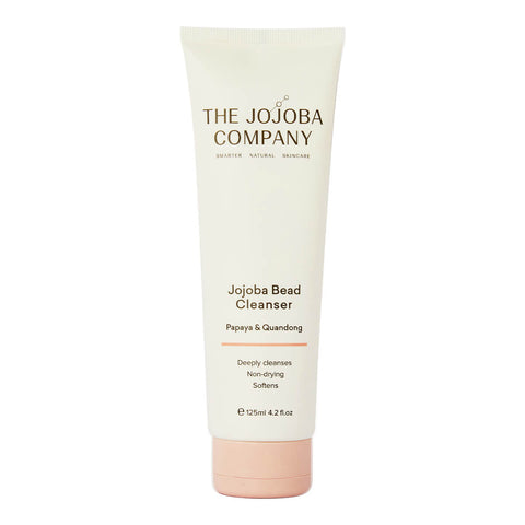 The Jojoba Company Jojoba Bead Cleanser 125ml in a cream squeeze tube with a pink cap end, standing upright, front view on a plain white background