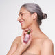 Model holding 30ml The Jojoba Company Neck & Décolletage Lifting Concentrate.