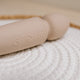 The Natural Love Company Cassia, a dual-ended marvel with a deeply rumbly wand vibrator on one end paired with a G-spot targeting dildo on the other, all encased in buttery soft pastel pink silicone.