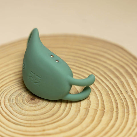The Natural Love Company Cilantro, a rabbit eared cock ring, with a recycled ocean plastic core and buttery smooth sanitary grade silicone exterior, finished in a contemporary peacock blue. Designed for a fusion of pleasure for both partners during partnered sex.