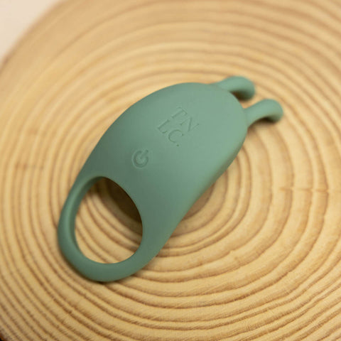 The Natural Love Company Cilantro, a rabbit eared cock ring, with a recycled ocean plastic core and buttery smooth sanitary grade silicone exterior, finished in a contemporary peacock blue. Designed for a fusion of pleasure for both partners during partnered sex.