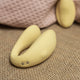 The Natural Love Company Cistus, a remote controlled (remote included) U-shaped vibrator with dual vibrating motors (one at each end), it's crafted with a recycled ocean plastic internal body dressed in a buttery smooth silicone casing, which comes in a creamy yellow hue.