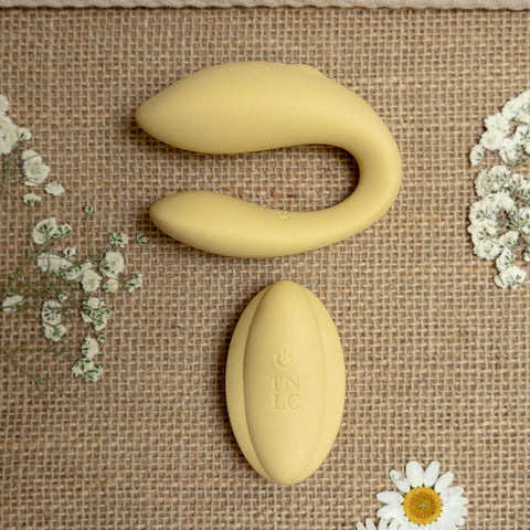 The Natural Love Company Cistus, a remote controlled (remote included) U-shaped vibrator with dual vibrating motors (one at each end), it's crafted with a recycled ocean plastic internal body dressed in a buttery smooth silicone casing, which comes in a creamy yellow hue.
