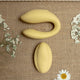 The Natural Love Company Cistus, a remote controlled (remote included) U-shaped vibrator with dual vibrating motors (one at each end), it's crafted with a recycled ocean plastic internal body dressed in a buttery smooth silicone casing, which comes in a creamy yellow hue.