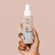 Hand holding The Natural Love Company Simply Toy Cleaner, a gentle and toy safe water-based sex toy cleaner.