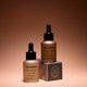 Two bottles of 'Three Warriors' tanning products on a brown background