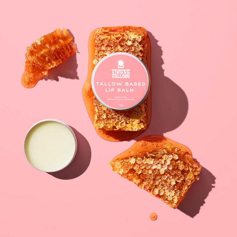 35ml tin Thrive Tallow Tallow Based Lip Balm placed on top of honeycomb. An all-natural formula that leaves the lips deeply hydrated.