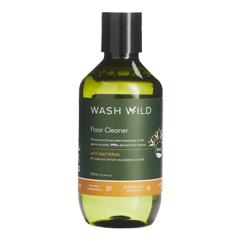 Wash Wild Floor Cleaner 300ml in a green glass bottle with a black cap and an orange band, front view on a plain white background