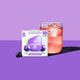 waterdrop Microdrink Boost Blackcurrant 12 servings lifestyle shot of the box beside a glass of pink drink with ice on a purple backdrop