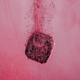 waterdrop Microdrink Taster Pack lifestyle shot of a dark berry cube dropping into pink water with fizzing bubbles, styled lifestyle photo