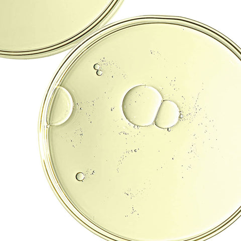 Close-up of a clear plastic lid with bubbles on a white background.